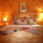 The cozy bedroom in Jack's Little Log Cabin