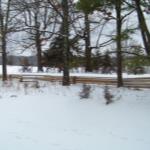 The view of the front yard and river valley with snow on the ground